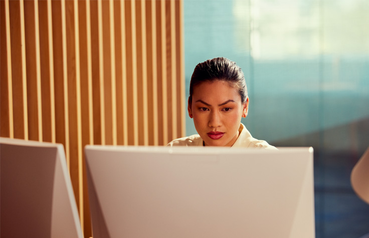 Scientist analyzing data behind computer screen