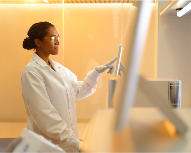 Scientist using MiSeq i100 system in a lab setting